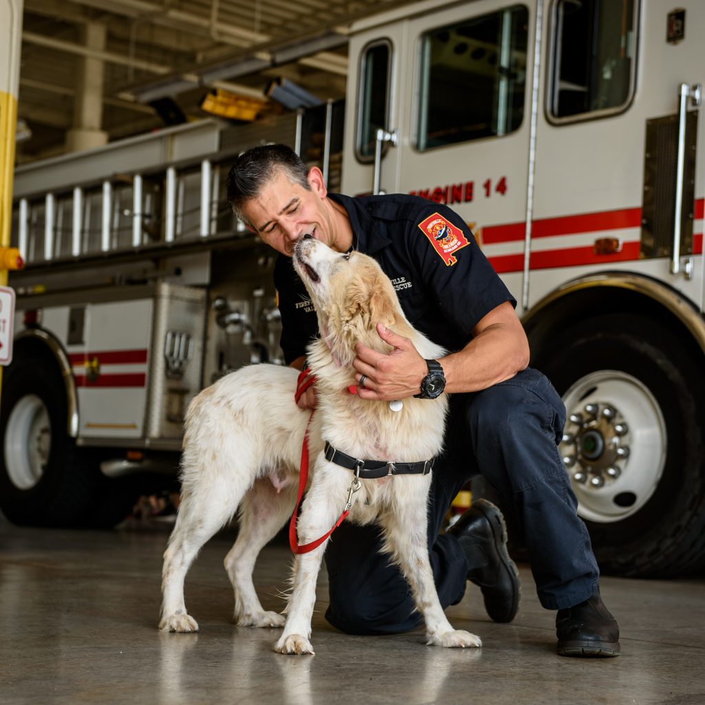 ADOPTED: Mosie, who has since been adopted, lands a kiss on Firefighter Jeff Valdez