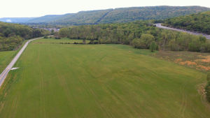 An aerial view of a large field near the intersection of Old Big Cove Road and Cecil Ashburn Drive