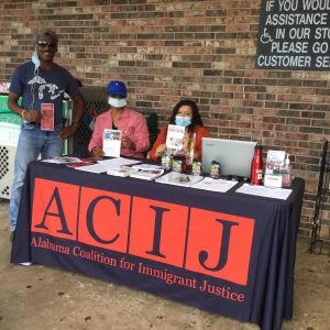 Flora E. Tapia-Johnson, center, participates at an event with other representatives from the Alabama Coalition for Immigrant Justice.