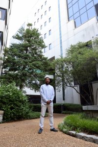 Akeem Davis stands in the courtyard outside the Blackwell Tower at Huntsville Hospital.