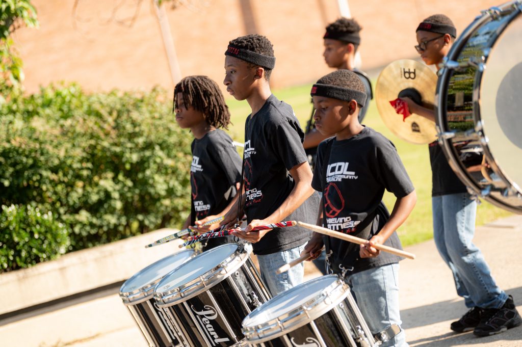 The Huntsville Community Drumline will perform outside City Hall on September 8, 2022. The children wear his HCDL black t-shirts and play their instruments.