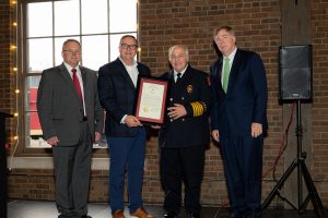State Reps. Rex Reynolds and Andy Whitt present Huntsville Fire & Rescue Service Chief Howard McFarlen and Mayor Tommy Battle with a proclamation acknowledging HFR's 200 years of service on Dec. 8, 2022.