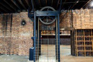 A freight elevator is seen in an empty brick building in downtown Huntsville.