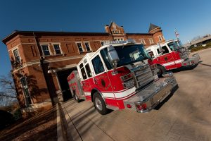 A pair of Huntsville Fire & Rescue trucks leave Fire Station #1.