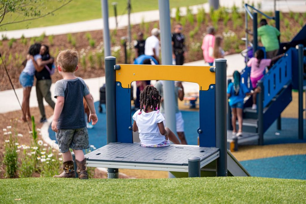 Children play on playground equipment outdoors