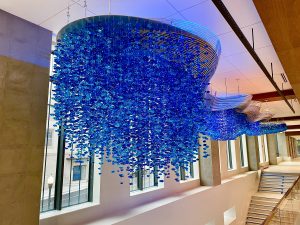 An art installation featuring thousands of hanging crystals in the new City Hall. The crystals are blue in this photo but also change colors.