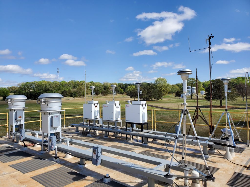 air quality testing station in green field with trees